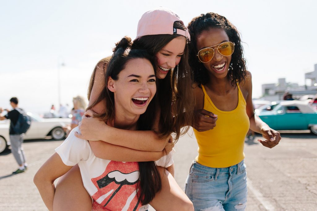 A Santa Cruz lifestyle shoot with three models laughing and having fun together on a sunny day.