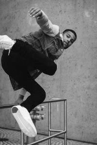 Model Emmanuel Augustus jumping over a fence for Levis inspired lifestyle photo shoot in San Francisco, California