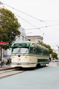 Green trolley making its way through the Castro District