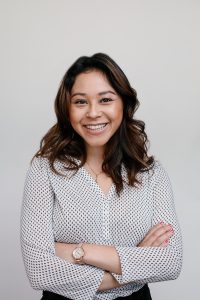WeWork member smiling with crossed arms for a studio portrait as a part of a project with Glamsquad