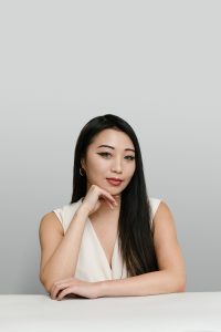 UX designer Annia Chen in a casual studio portrait.