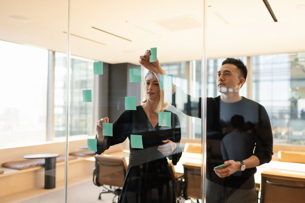 Two employees collaborating and using sticky notes at Turn River Capital office in San Francisco